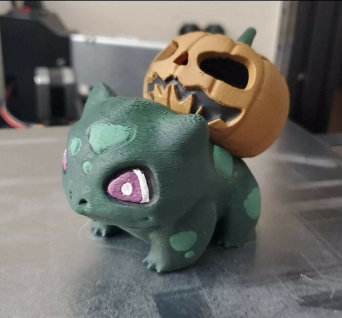 A Halloween-themed Bulbasaur with a pumpkin on its back, an example of useful things people printed with 3D printers.