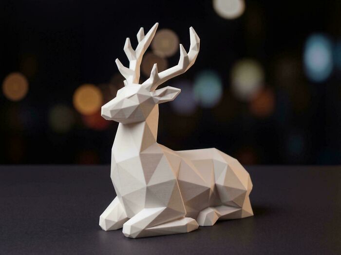 A geometric white deer figurine with sharp angles, showcasing cool things people printed with their 3D printers.