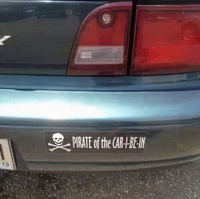 A car bumper with a sticker that reads Pirate of the CAR-I-BE-IN, a classic dumb pun.