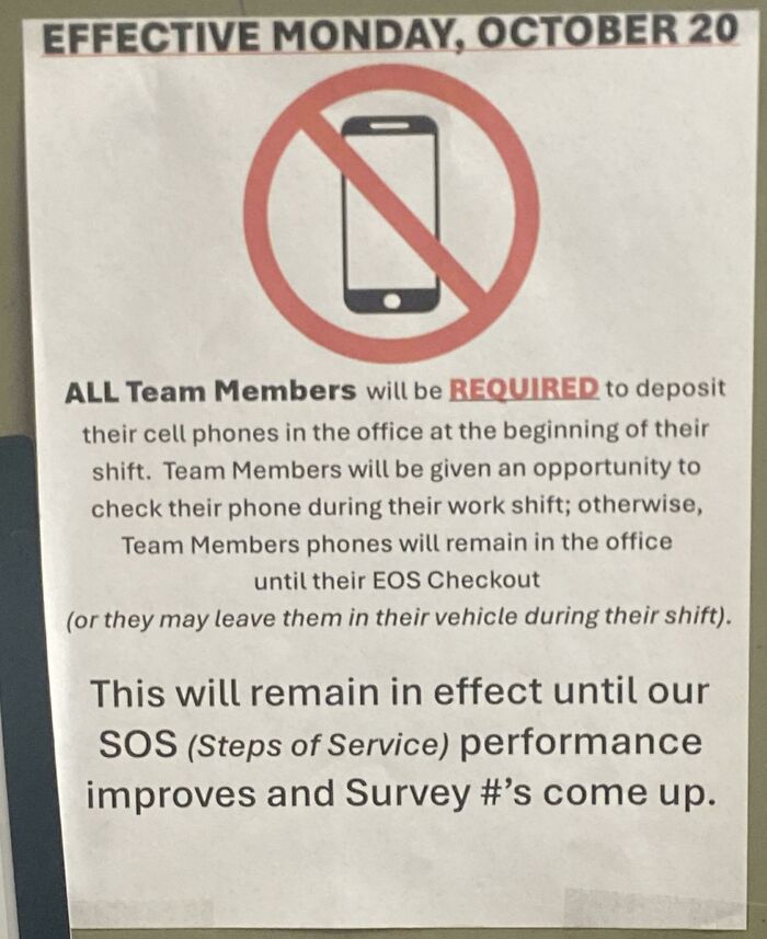 A sign prohibiting cell phones for service industry workers, stating phones must be deposited in the office.