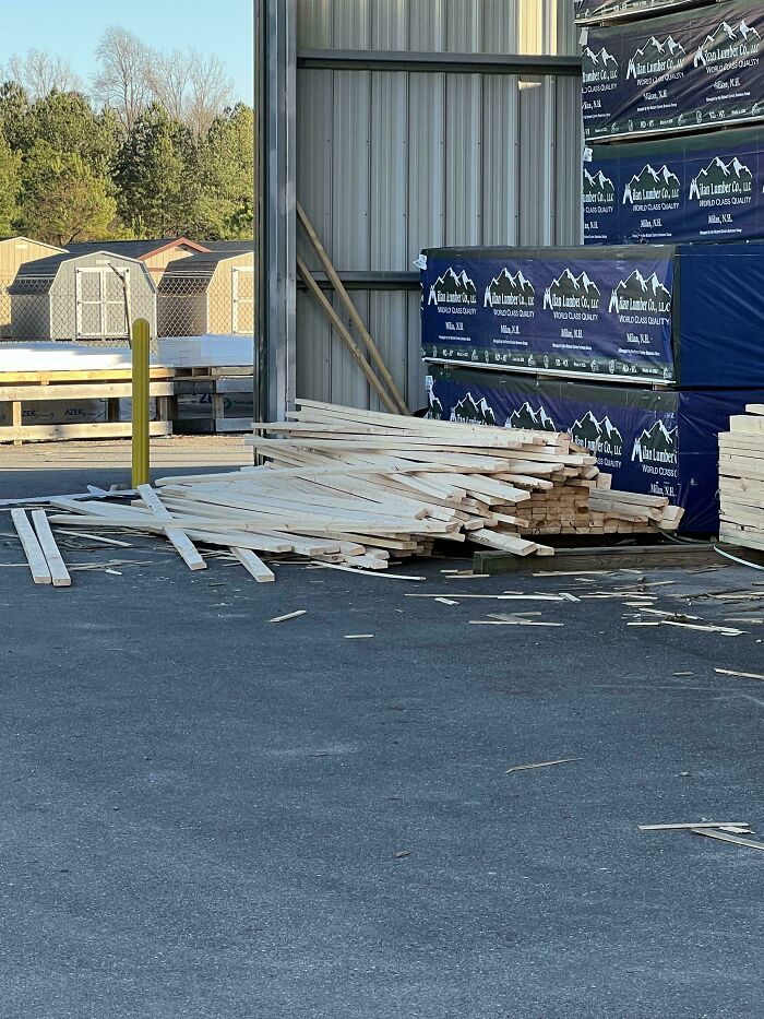Discarded wood planks outside a lumber yard, revealing a disorganized site by service industry workers.