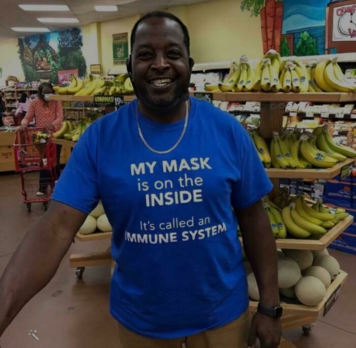 A man in a grocery store wearing a t-shirt saying My mask is on the inside, displaying stupidity online.
