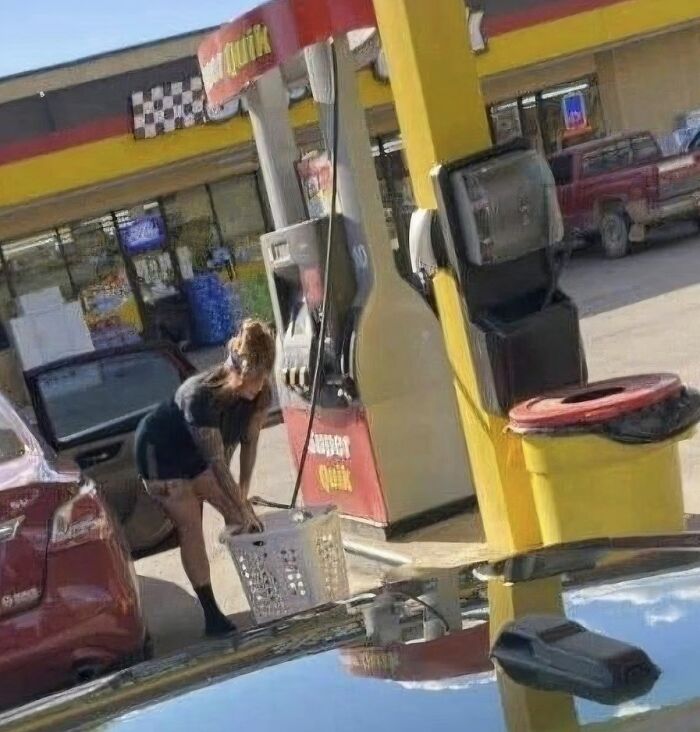 A woman doing laundry at a gas station, an unfortunate display of stupidity.