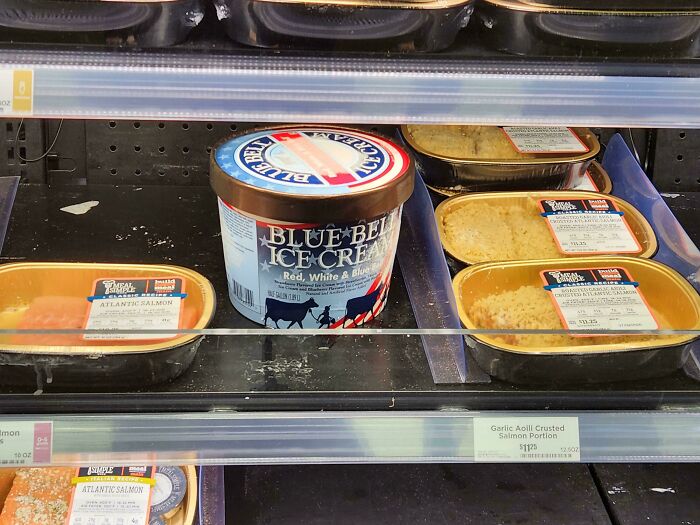 A single tub of Blue Bell ice cream in a mostly empty freezer aisle, showing the daily struggles of service industry workers.