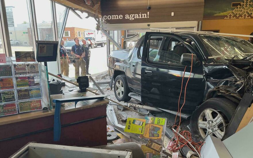 A black pickup truck crashed through the front of a store, displaying a rough day behind the wheel.