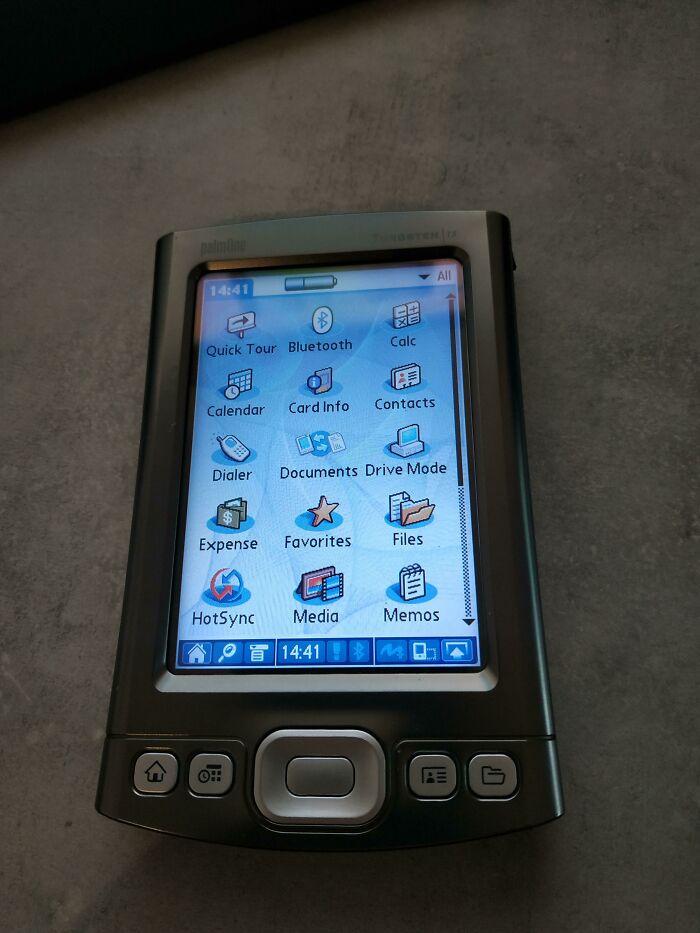 Close-up of a vintage PalmOne Tungsten C PDA displaying its menu, a piece of genius technology from the past.