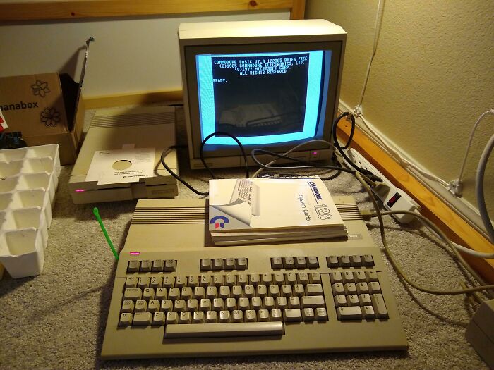 A vintage Commodore 128 setup with a monitor and keyboard, a classic example of genius technologies.
