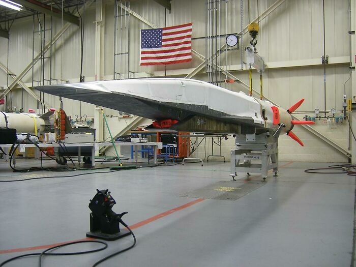 A sleek, unmanned aerial vehicle (UAV) or drone in a hanger, demonstrating advanced technologies that make everyday life easier.