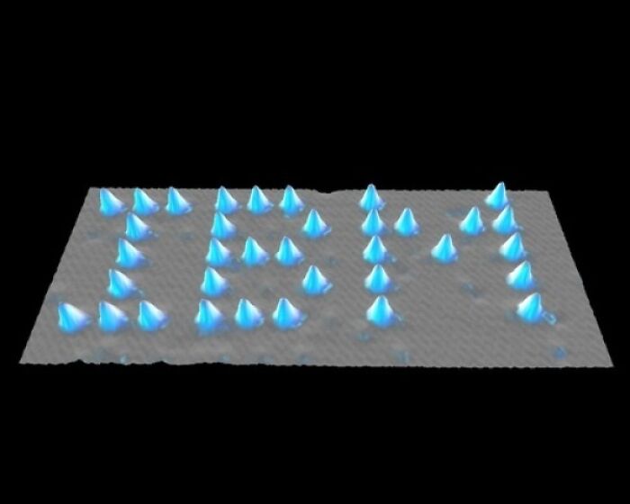 The IBM logo created with individual atoms, representing genius technologies.
