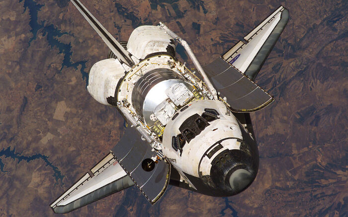 Space Shuttle in orbit, an incredible example of genius technologies enabling space exploration.