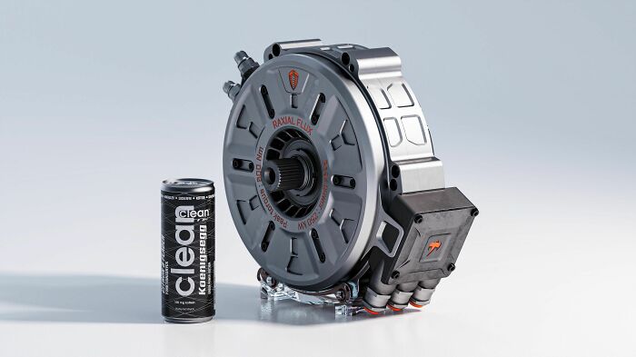 A small, powerful radial flux electric motor, a marvel of genius technologies, stands next to an energy drink can.