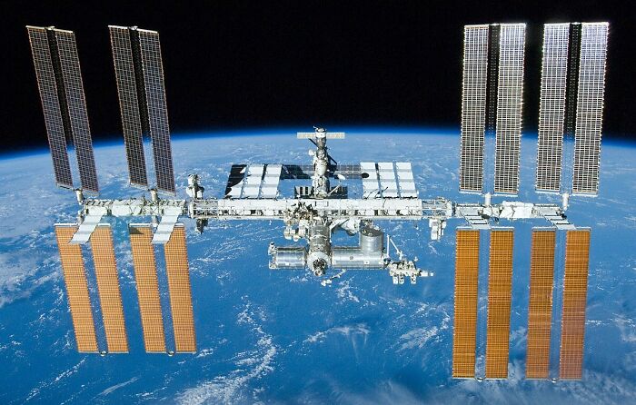 The International Space Station, a genius technology, orbits Earth, showcasing advancements that make everyday life easier.