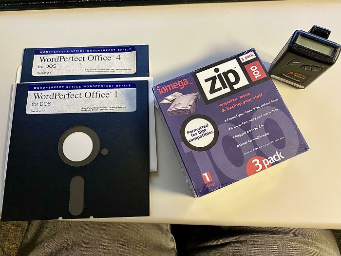 Old WordPerfect Office floppy disks, Zip drive, and a pager, representing genius technologies from the past.