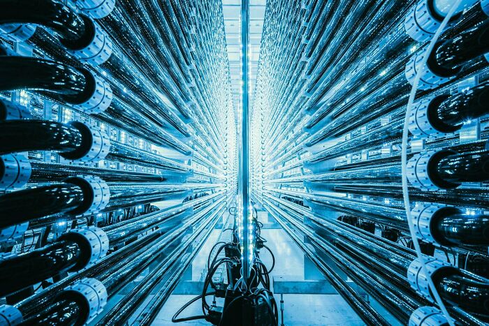 Rows of blue-lit server tubes, representing genius technologies that make everyday life easier through data.