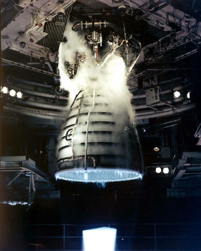A rocket engine undergoing a test fire, billowing smoke, symbolizing advanced technologies in space exploration.