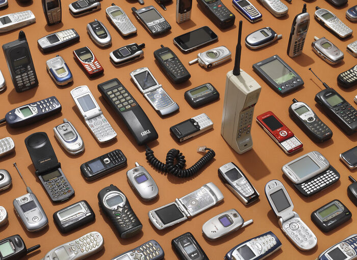 A collection of old cell phones and mobile technologies, illustrating the evolution of communication and everyday life.