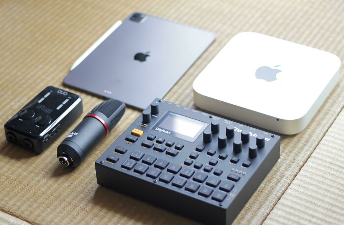 A collection of modern Apple devices and music production gear, genius technologies for everyday life.