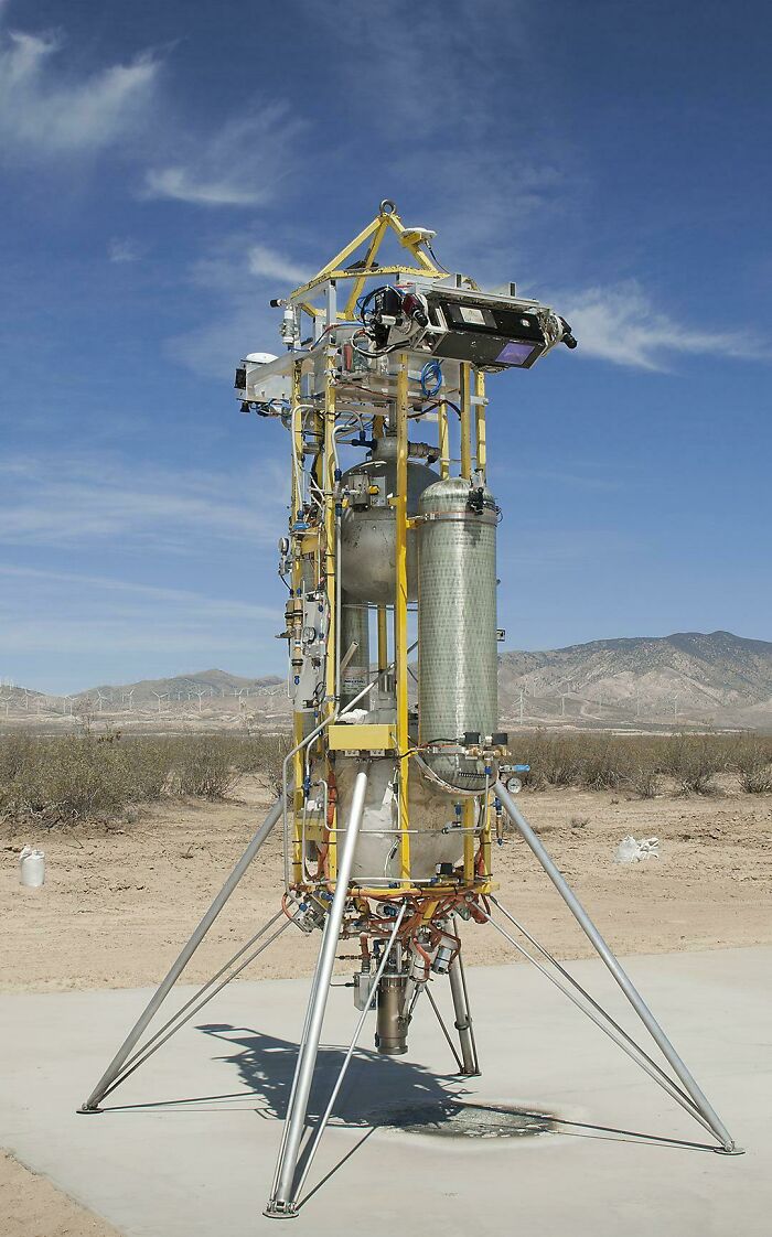 A tall, complex piece of machinery in a desert landscape, highlighting genius technologies.