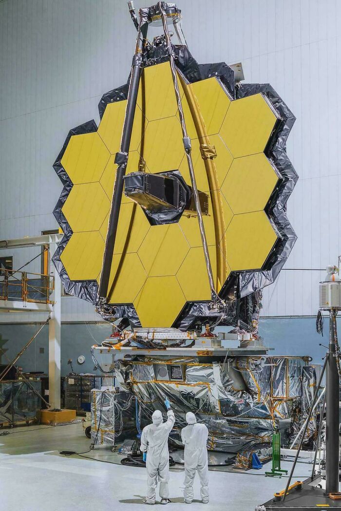 Engineers inspecting the James Webb Space Telescope's golden mirrors, showcasing advanced technologies that make everyday life easier.