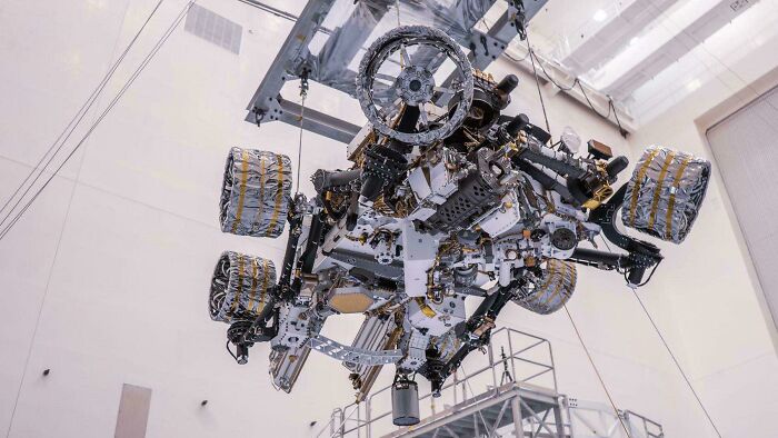 The Perseverance Mars rover under construction, an example of genius technologies pushing exploration and making everyday life easier.