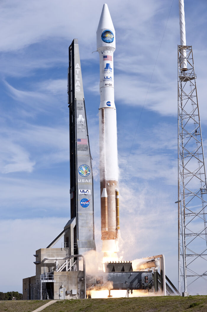A powerful Atlas V rocket launching skyward, showcasing advanced technologies that make everyday life easier with space exploration.