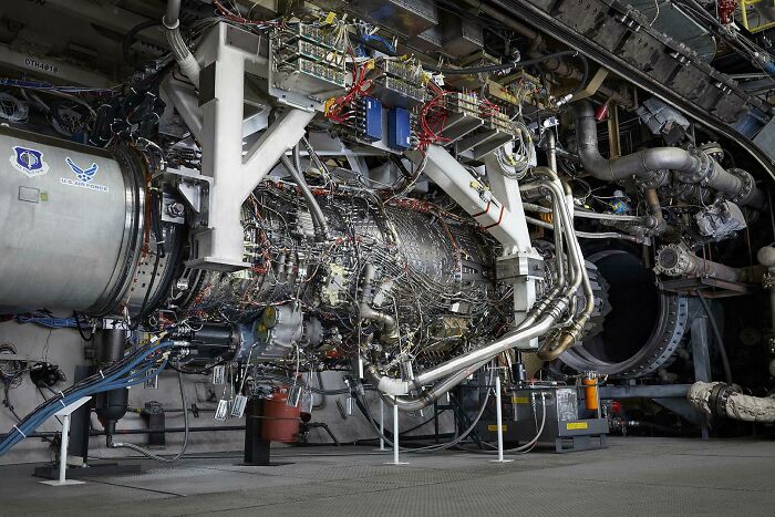 An intricate, large-scale jet engine, a marvel of genius technologies making everyday life easier, filled with wires and components.