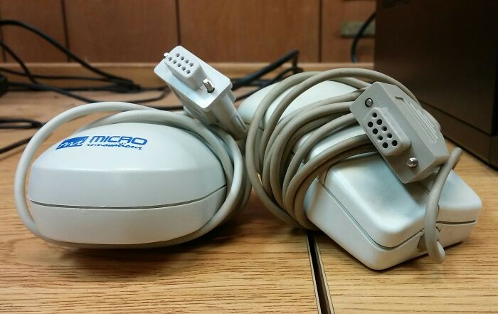Two vintage computer mice with tangled cables, representing older technologies that made everyday life easier.