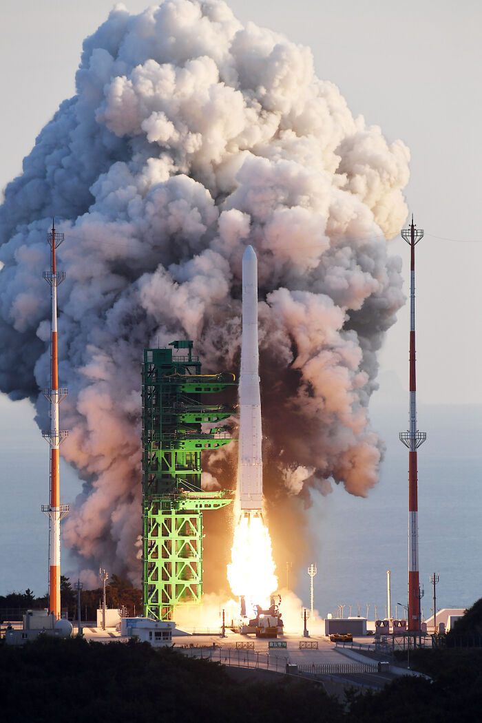A rocket launch with a massive plume of smoke, representing genius technologies propelling exploration and making everyday life easier.