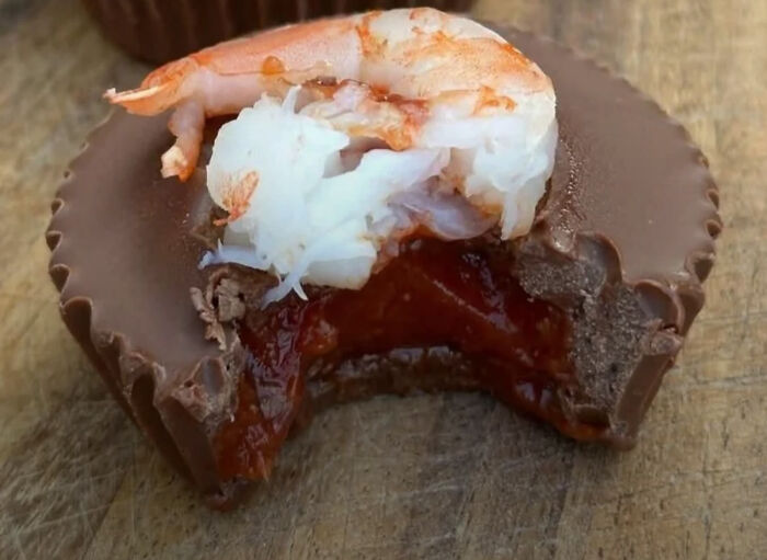 A chocolate peanut butter cup with a shrimp and cocktail sauce filling, a truly creepy and confusing image.