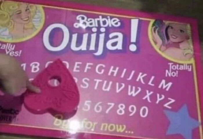 A creepy and confusing image of a Barbie Ouija board with a pink planchette, needing a priest.