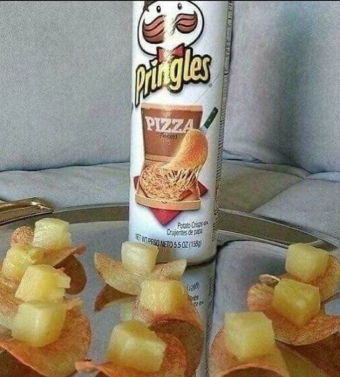 Pringles pizza flavored potato chips topped with pineapple chunks, a confusing food combination, a creepy and confusing image.