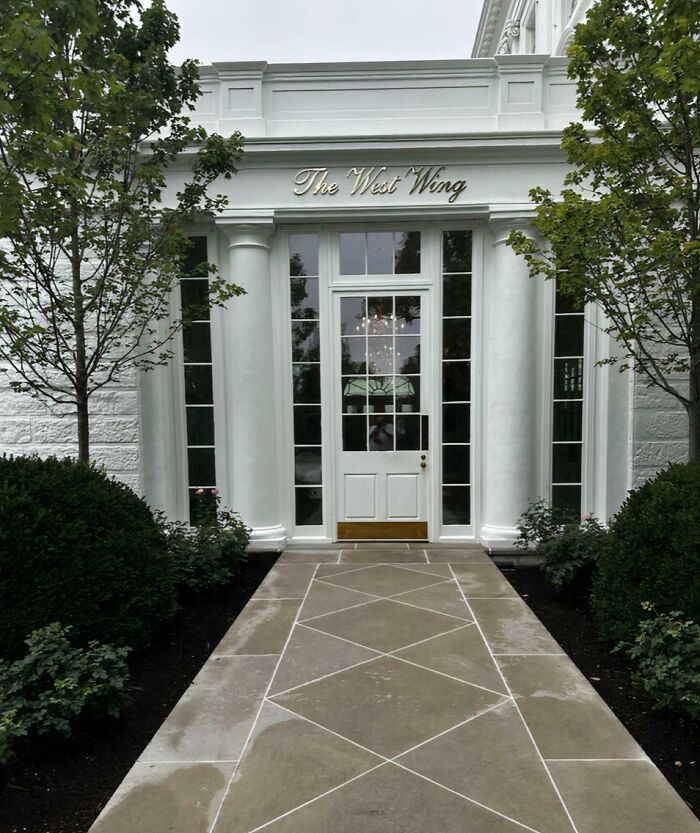 The elegant entrance of a building labeled The West Wing, showcasing classic architectural home decor elements.