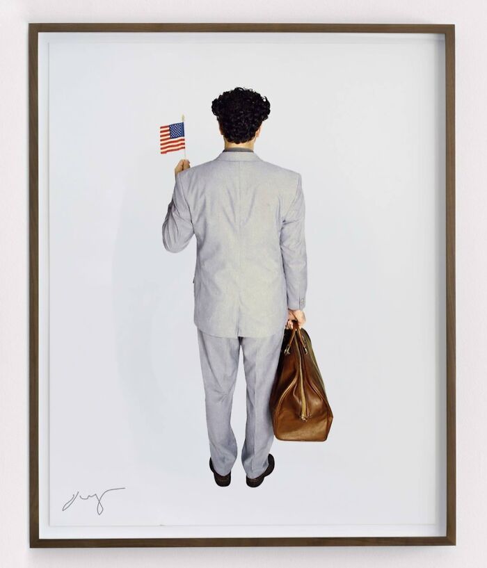 An artist reimagined a masterpiece from behind: a man in a grey suit holding a US flag and a bag, seen from the back.