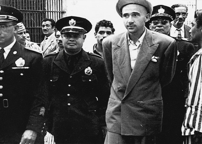 The 24-year-old is escorted by police, his head bowed, as part of the chilling chain of events from a street fight. The 24-year-old is escorted by police, his head bowed, as part of the chilling chain of events from a street fight.