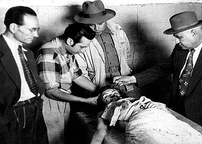 Men gathered around a prone, injured person, illustrating the chilling chain of events from a street fight. Men gathered around a prone, injured person, illustrating the chilling chain of events from a street fight.
