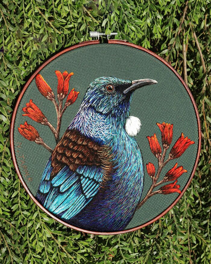 Colorful blue and brown bird in a green embroidery hoop art project