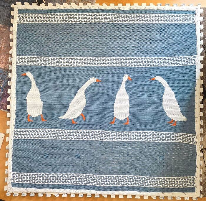 Crochet blanket with white geese on blue background creative crochet project