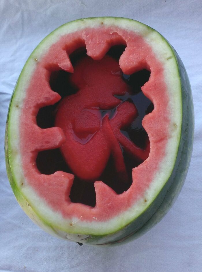 A watermelon carved to look like a baby in a womb, a piece of disgusting food.