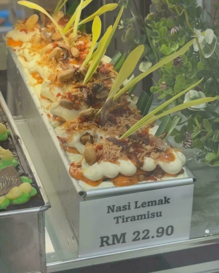 Disgusting food: Nasi Lemak Tiramisu with creamy topping, nuts, and green garnish, priced at RM 22.90.