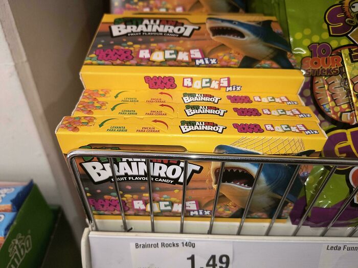 Disgusting food: Brainrot Rocks fruit flavour candy with a shark on the packaging displayed in a store.
