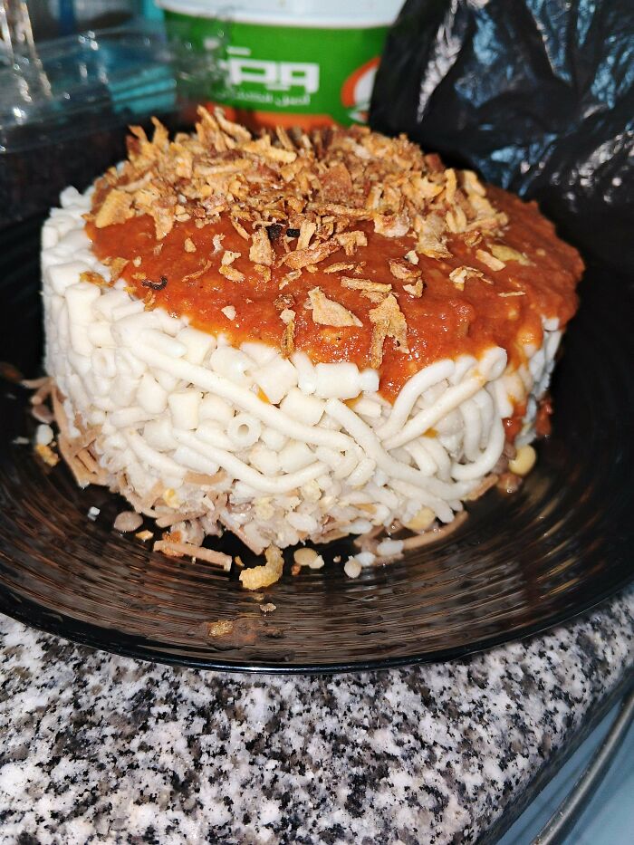 Disgusting food: A tall, cylindrical dish of pasta topped with red sauce and crispy fried onions.