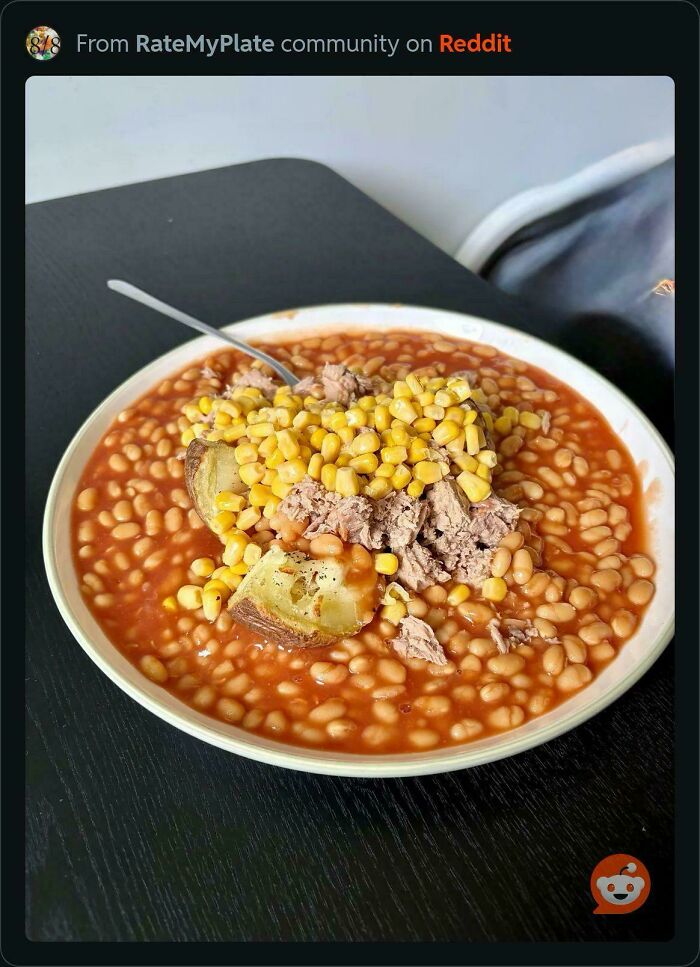 Stupid food with a plate of baked beans, corn, and tuna on toast, an unappetizing food combination.