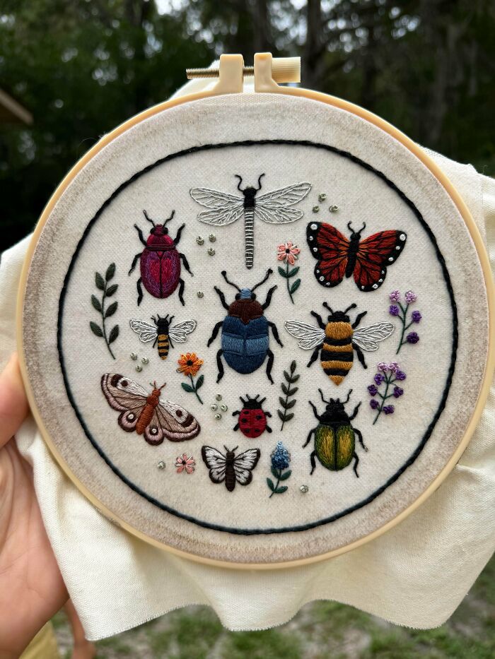 An embroidery project displaying various colorful bugs and insects