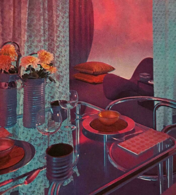 A vibrant dining setting with red and purple hues, glass table, and flowers captures 1970s and 1980s interior design.