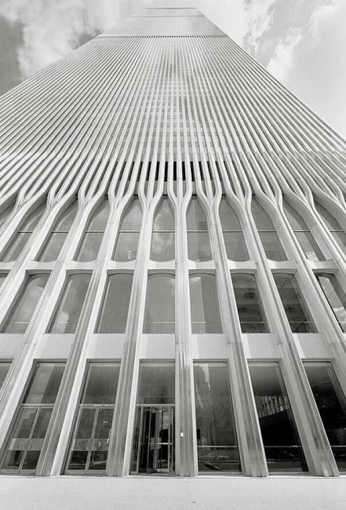 A low-angle, black and white shot of a skyscraper's exterior, a classic example of 1970s and 1980s architecture.