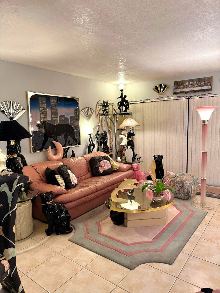 A living room filled with eclectic decor, a pink sofa, and unique lamps, reflecting 1970s and 1980s interior design.