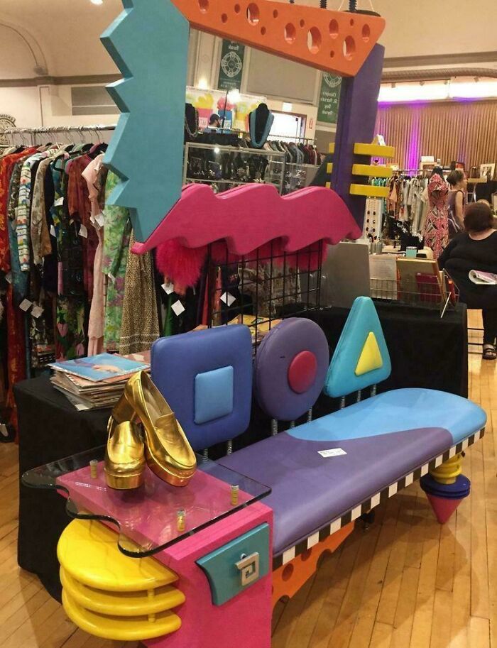 A vibrant 1980s interior design Memphis-style bench with geometric shapes and bold colors at a market.