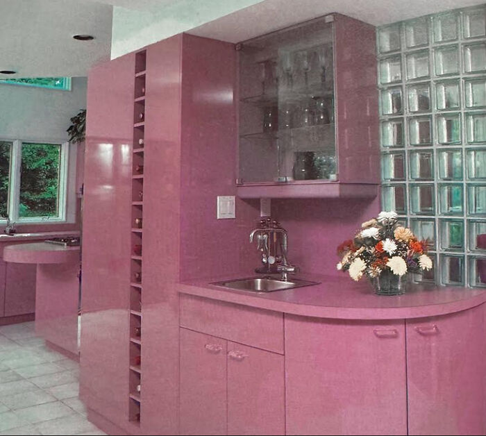 Pink kitchen with unique cabinets and glass block accents, a bold example of 1970s and 1980s interior design.