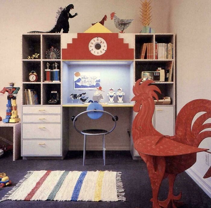 A child's room featuring 1970s and 1980s interior design with a desk, bookshelves, and various toys and decorations.
