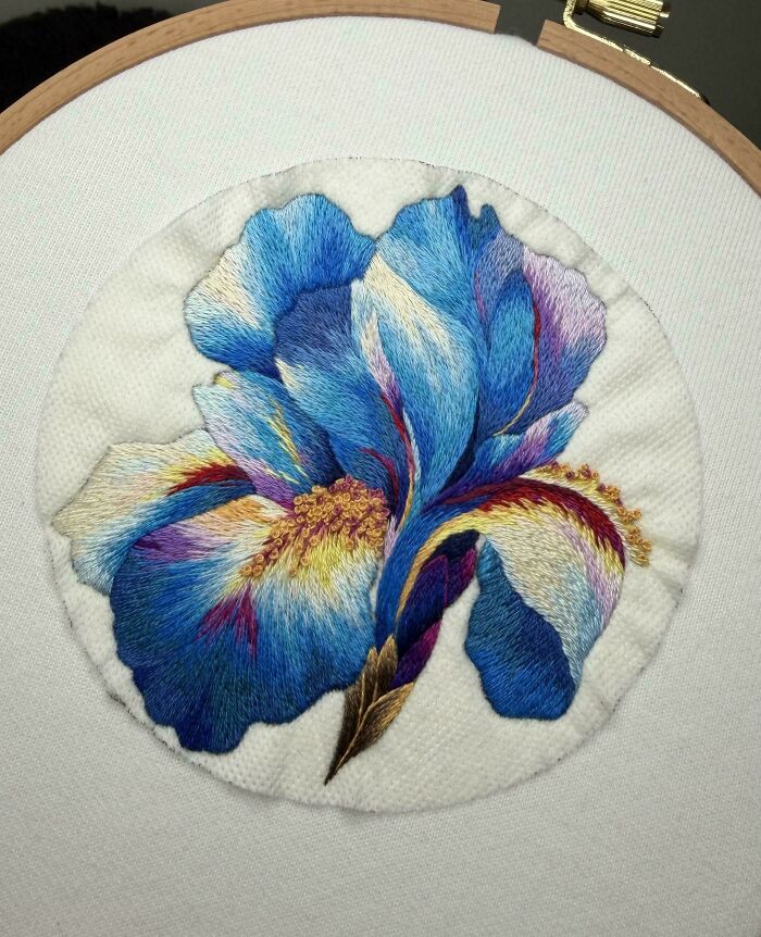 Intricate blue iris flower embroidery project
